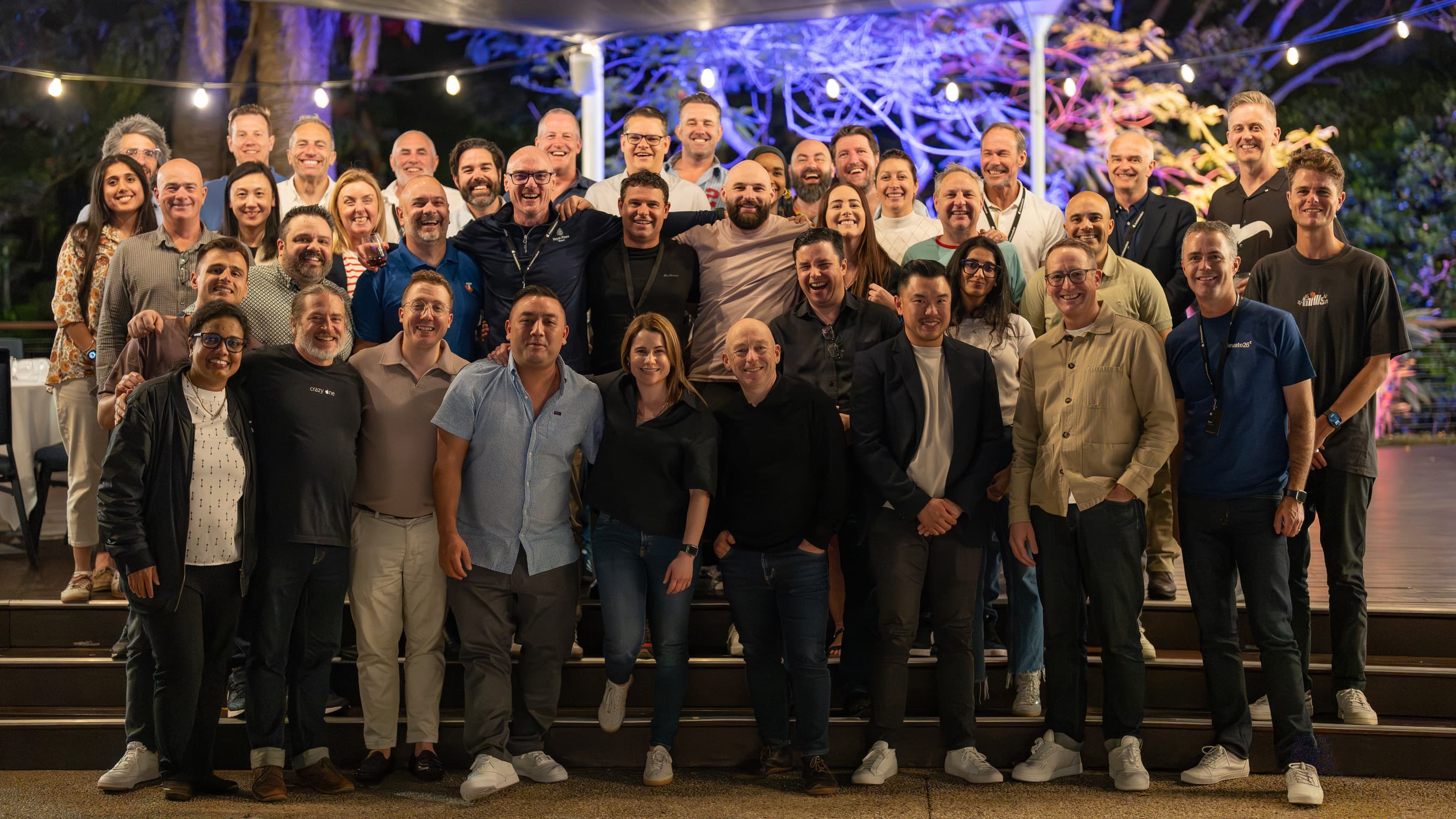 Apple Ambassadors participants gathered for a group photo at an evening event.